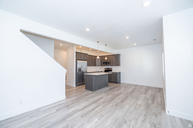 46 West 460 Smithfield, UT 84335 - Photo 5 of 31 Open-concept living area featuring light wood-finish flooring, recessed lighting, and a contemporary kitchen