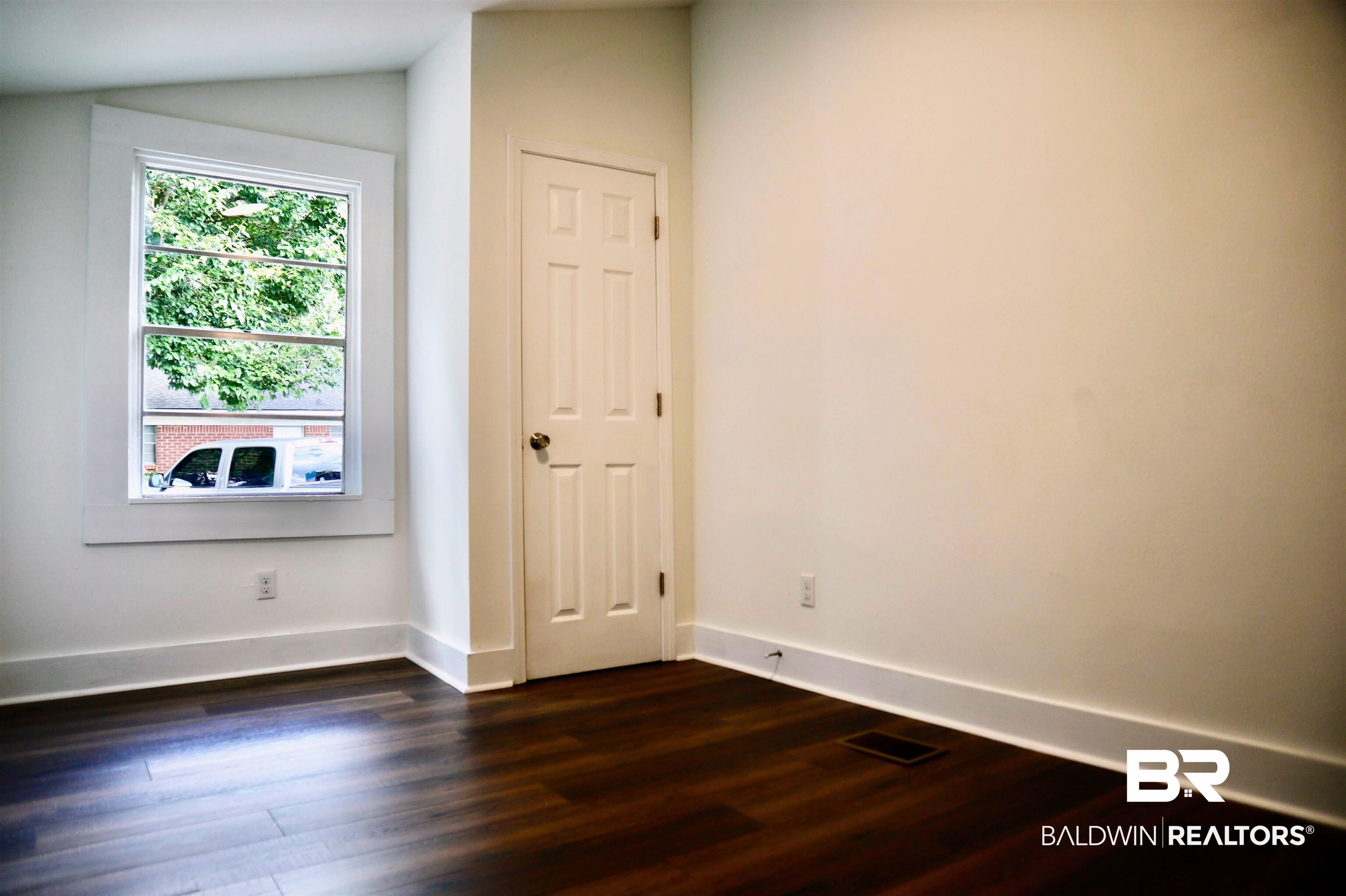 1009 Baltimore Street Mobile, AL 36605 - Photo 12 of 17 Spare room with dark wood finished floors and lofted ceiling