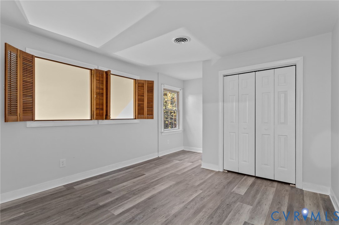 12601 Cottage Mill Road Midlothian, VA 23114 - Photo 21 of 50 a view of an empty room with wooden floor and a window