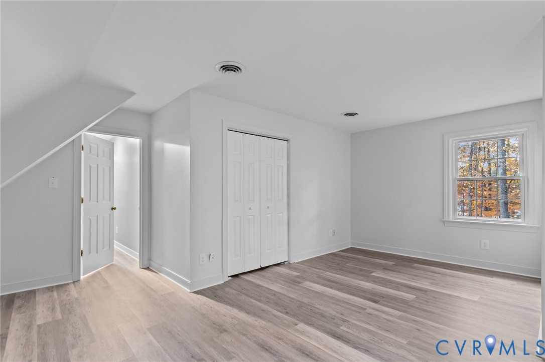 12601 Cottage Mill Road Midlothian, VA 23114 - Photo 24 of 50 a view of an empty room with wooden floor and a window