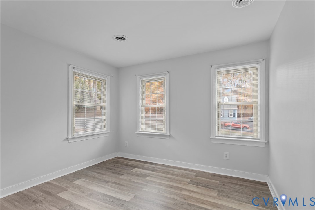 12601 Cottage Mill Road Midlothian, VA 23114 - Photo 25 of 50 a view of an empty room with wooden floor and windows