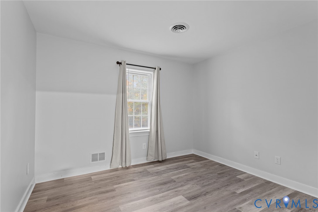 12601 Cottage Mill Road Midlothian, VA 23114 - Photo 27 of 50 an empty room with wooden floor and windows