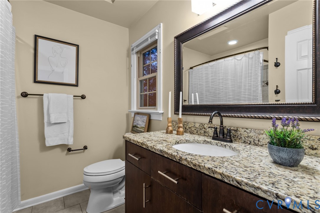 12601 Cottage Mill Road Midlothian, VA 23114 - Photo 35 of 50 a bathroom with a granite countertop sink a toilet and mirror