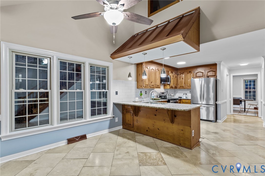 12601 Cottage Mill Road Midlothian, VA 23114 - Photo 46 of 50 a view of a kitchen with kitchen island a large window cabinets and stainless steel appliances