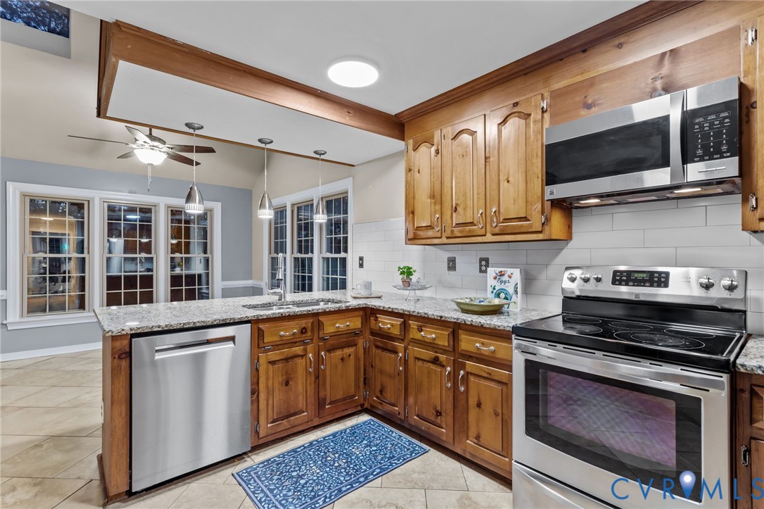 12601 Cottage Mill Road Midlothian, VA 23114 - Photo 47 of 50 a kitchen with stainless steel appliances granite countertop a stove and a sink