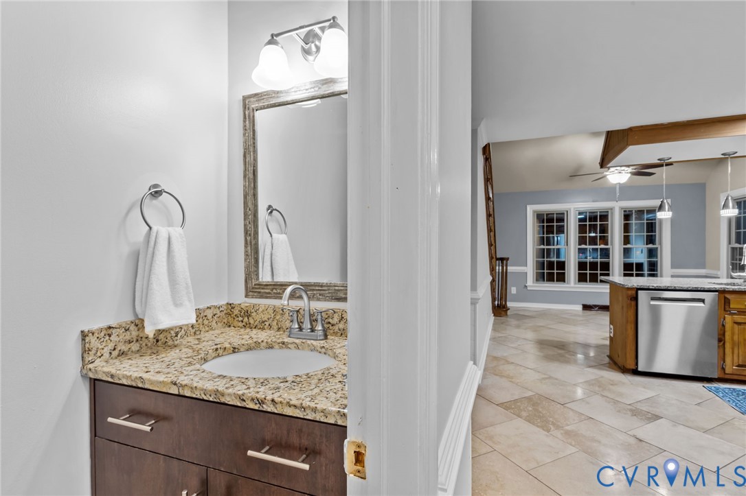 12601 Cottage Mill Road Midlothian, VA 23114 - Photo 49 of 50 a bathroom with a granite countertop sink and a mirror