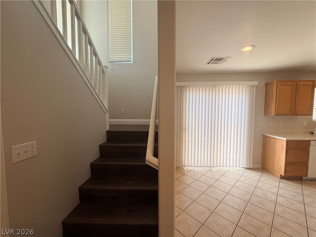 11953 Fairfax Ridge Street Las Vegas, NV 89183 - Photo 17 of 32 Clean lines define this versatile area, offering seamless flow between levels and direct outdoor access.