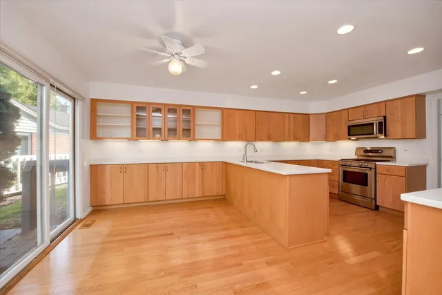 a view of a livingroom with furniture window and kitchen view