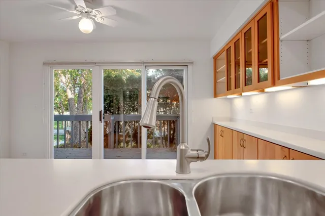 a view of a livingroom with a ceiling fan and window