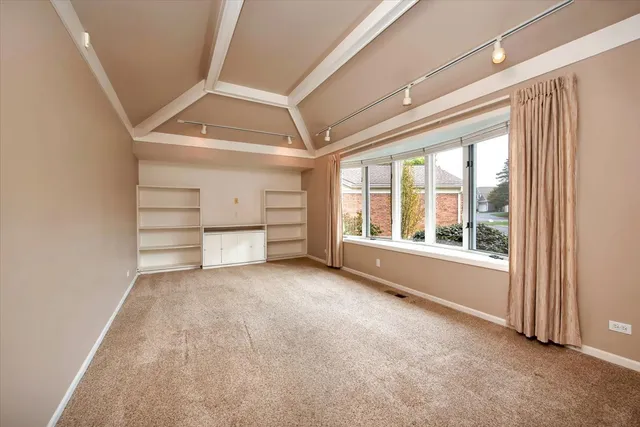 a view of empty room with ceiling fan