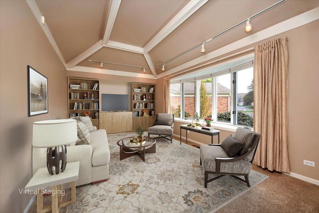 a view of a bedroom with a ceiling fan