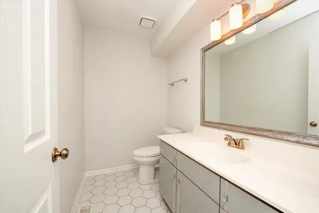 a bathroom with a sink a vanity a window and a bathtub