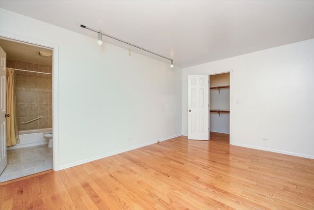 a view of a kitchen with wooden floor and a kitchen