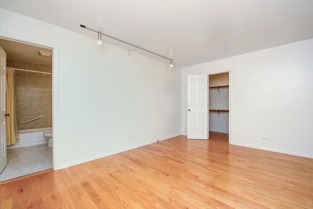 a view of a kitchen with wooden floor and a kitchen