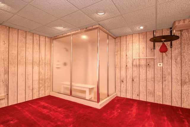 a picture of a bathroom with a shower and a mirror