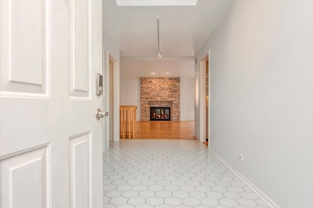 a view of a hallway that has an entryway door