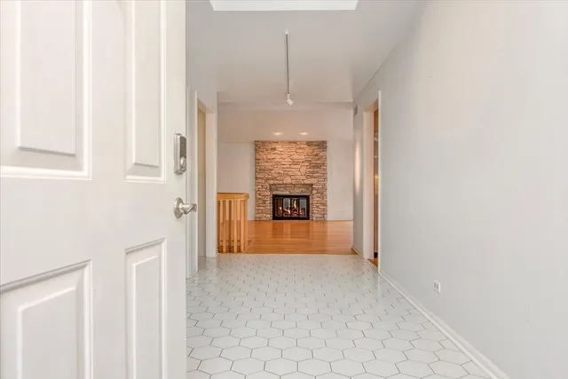 a view of a hallway that has an entryway door