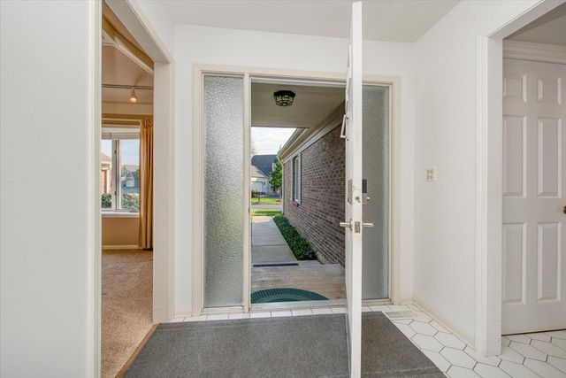 a view of a hallway with wooden floor and glass door