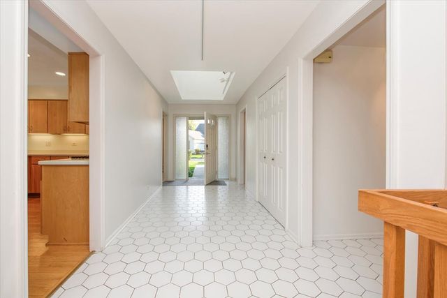 a view of empty room with wooden floor and fireplace