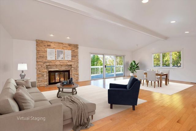 a view of empty room with wooden floor and windows