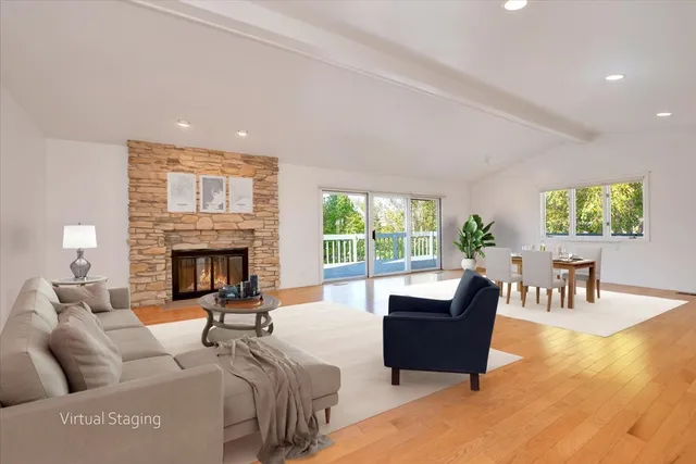 a view of empty room with wooden floor and windows