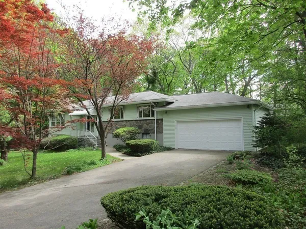 a front view of house with yard and green space
