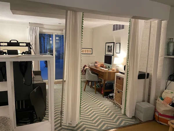 a view of living room filled with furniture and window