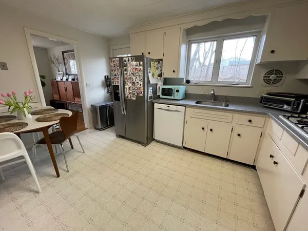 a kitchen with refrigerator and window
