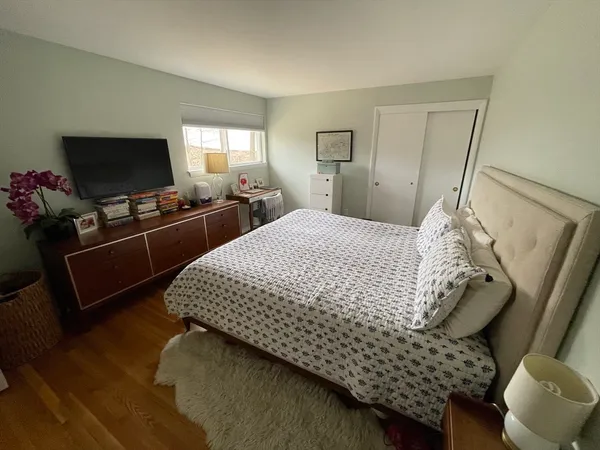 a bedroom with bed and flat screen tv