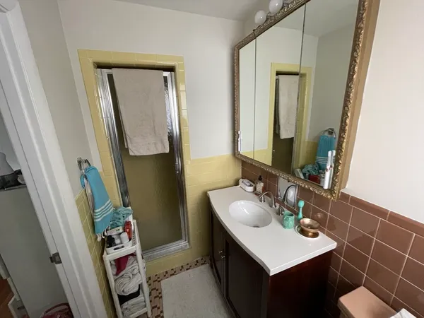 a bathroom with a sink vanity and a mirror
