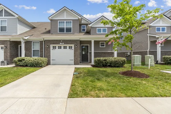 a front view of a house with a yard and garage