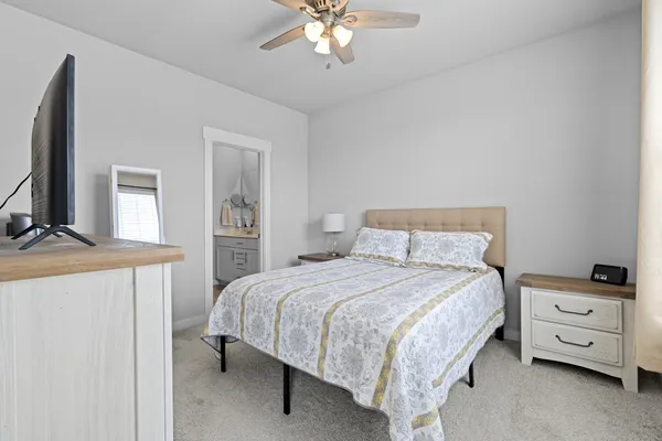 a bedroom with a bed and a chandelier