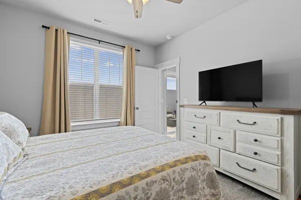 a bedroom with a flat screen television and a bed