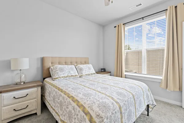 a bedroom with a bed and a lamp