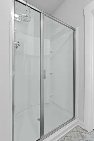 a bathroom with a glass shower door