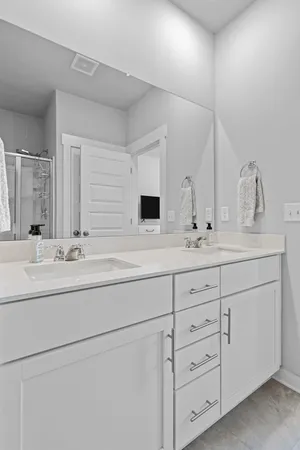 a bathroom with double sink and a mirror
