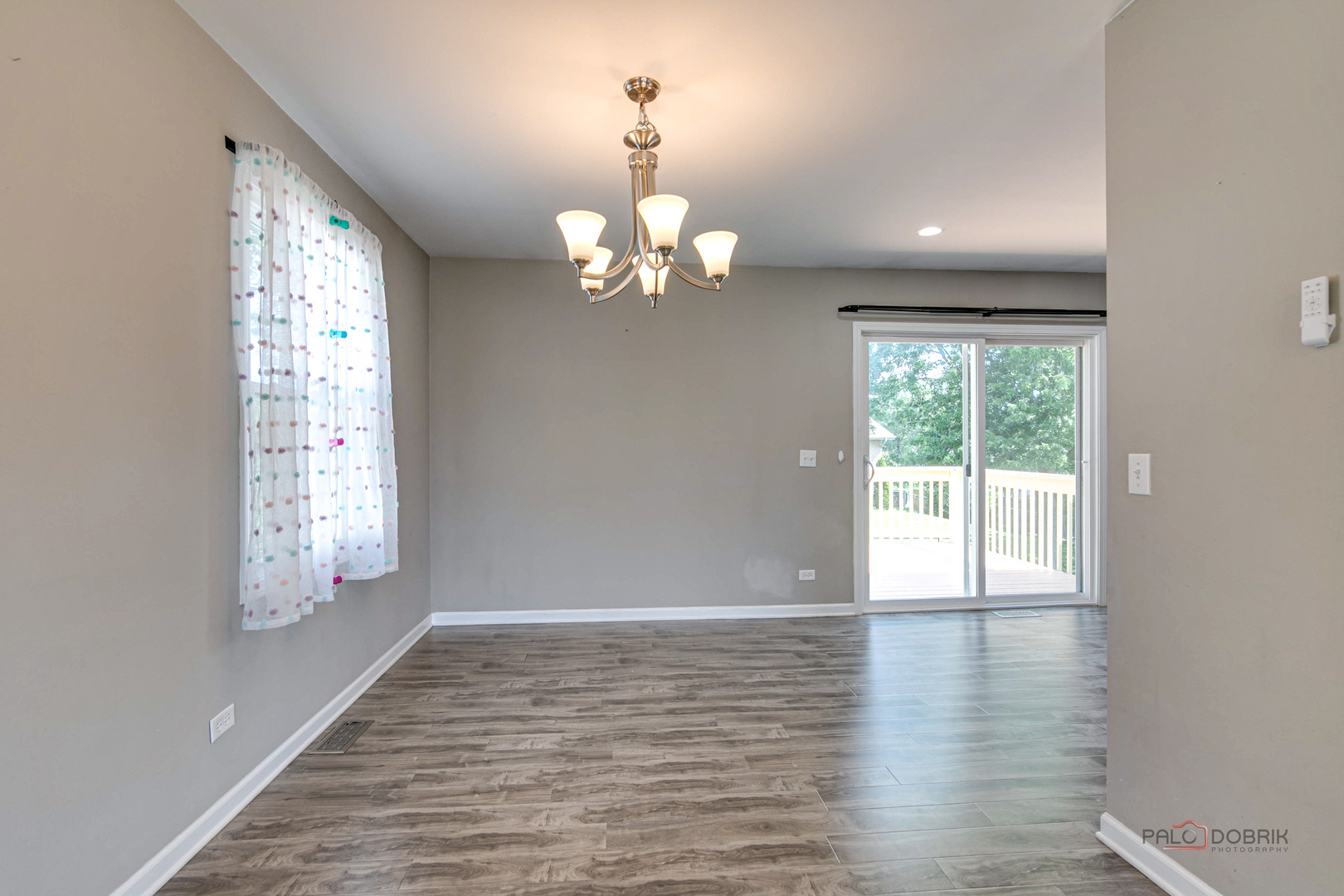 1030 Hassell Road Hoffman Estates, IL 60169 - Photo 12 of 35 a view of an empty room with wooden floor and a window