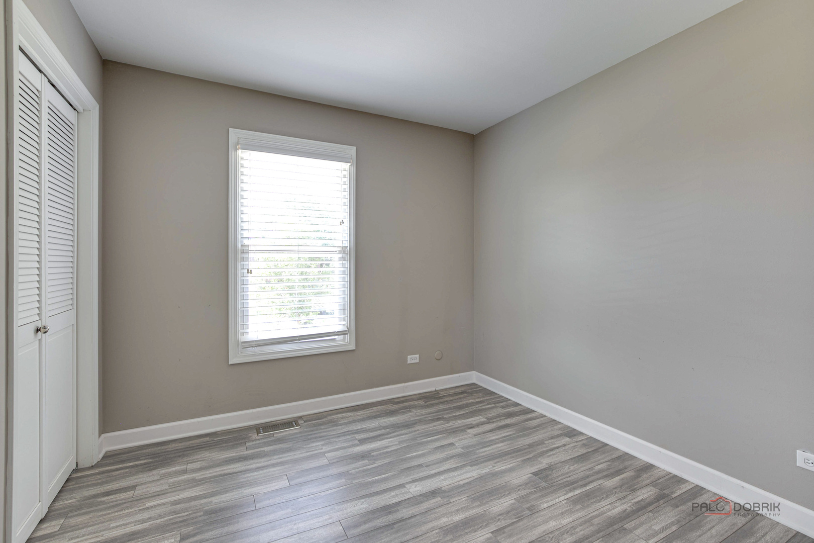 1030 Hassell Road Hoffman Estates, IL 60169 - Photo 15 of 35 an empty room with wooden floor and windows