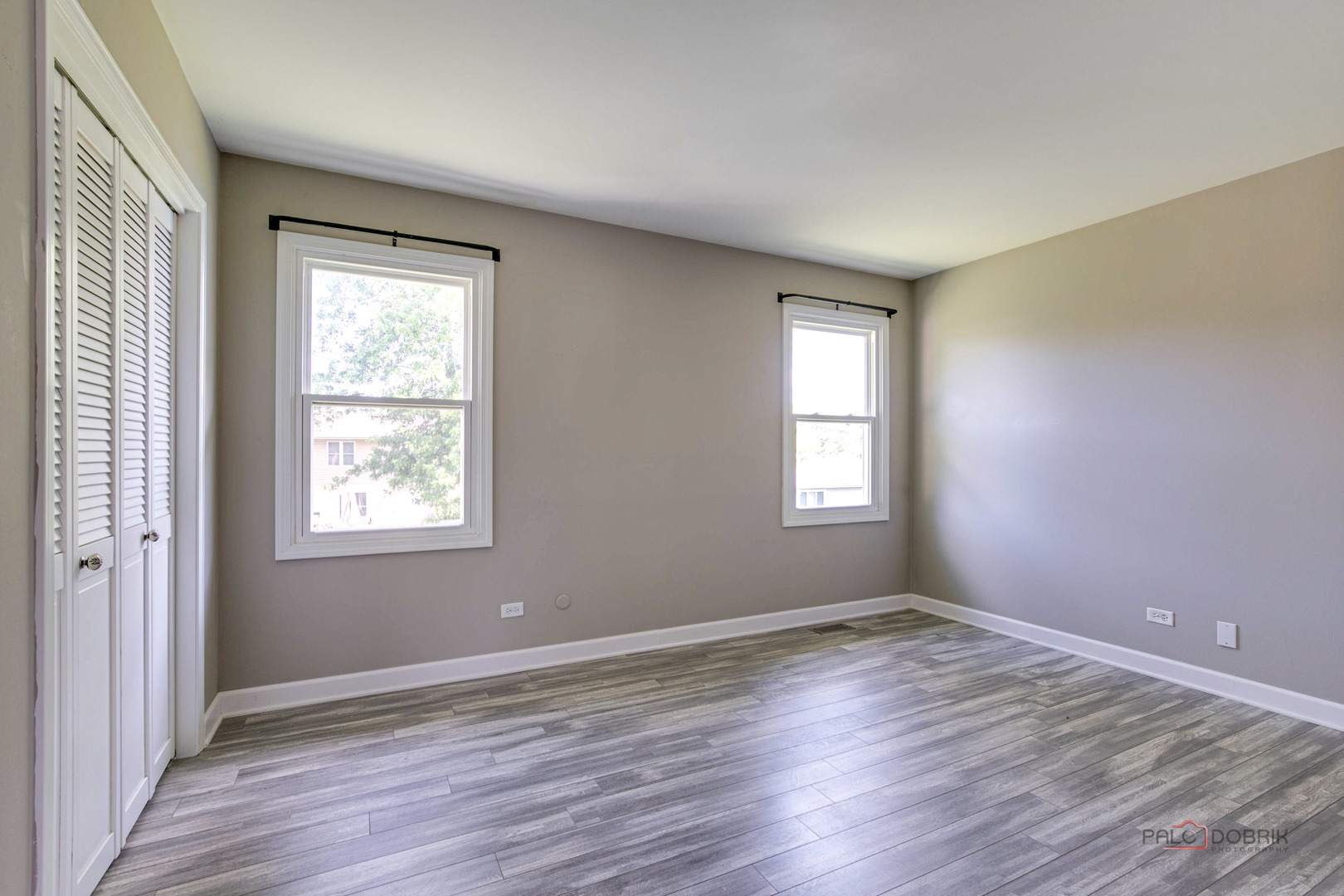 1030 Hassell Road Hoffman Estates, IL 60169 - Photo 16 of 35 a view of an empty room with wooden floor and a window