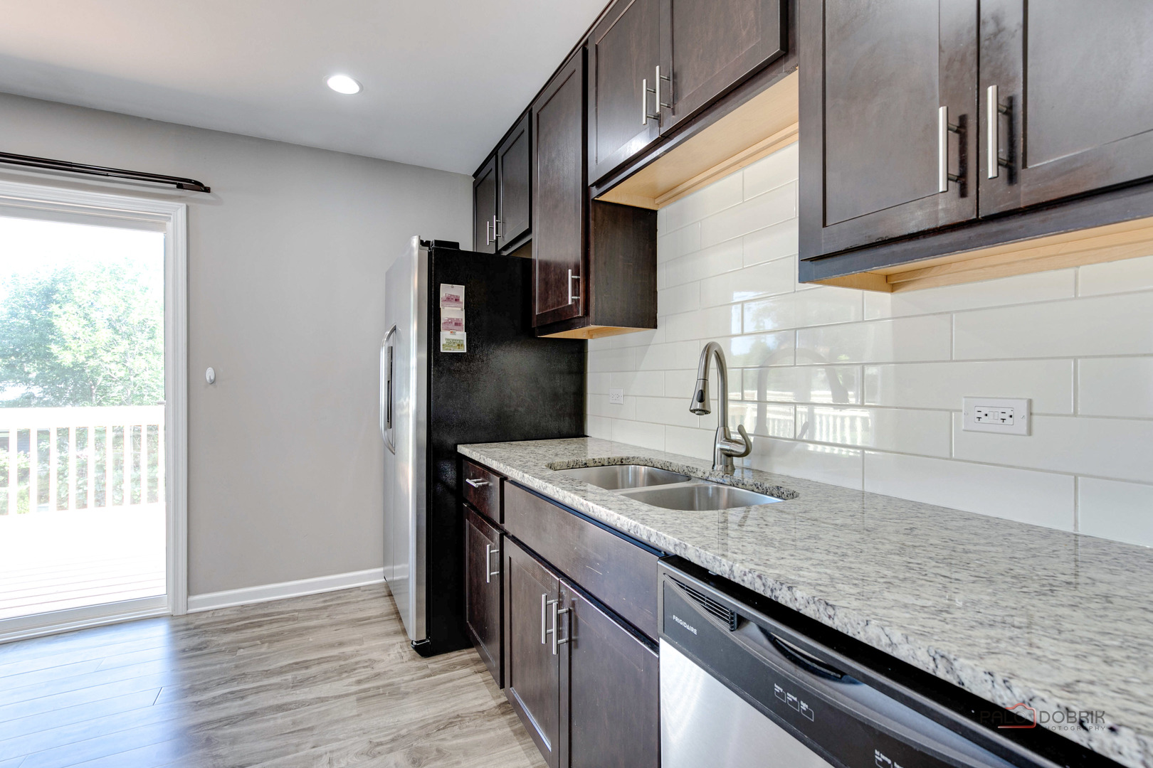1030 Hassell Road Hoffman Estates, IL 60169 - Photo 2 of 35 a kitchen with granite countertop a sink and a refrigerator