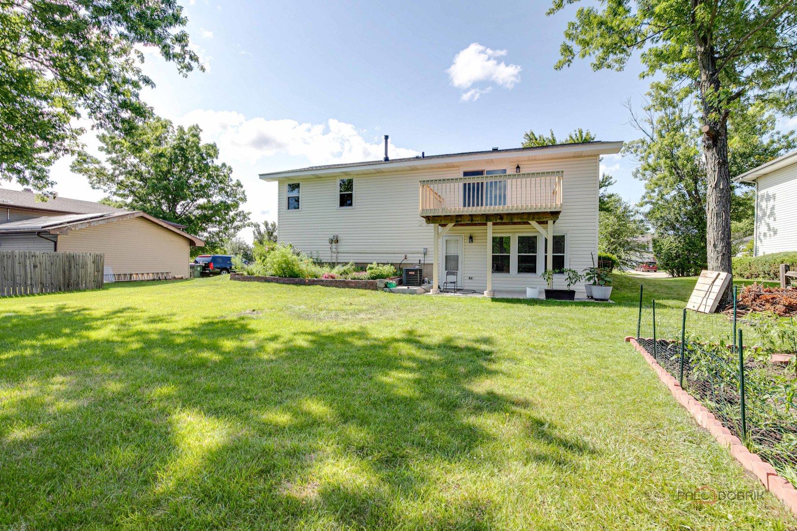 1030 Hassell Road Hoffman Estates, IL 60169 - Photo 31 of 35 a view of a house with a big yard and potted plants