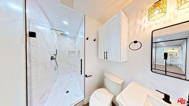 a bathroom with a bathtub shower sink and toilet