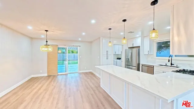a bathroom with a sink a large mirror and shower