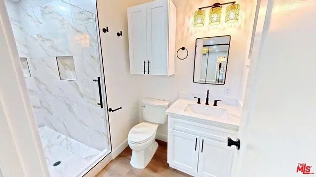 a white toilet sitting next to a bathroom sink