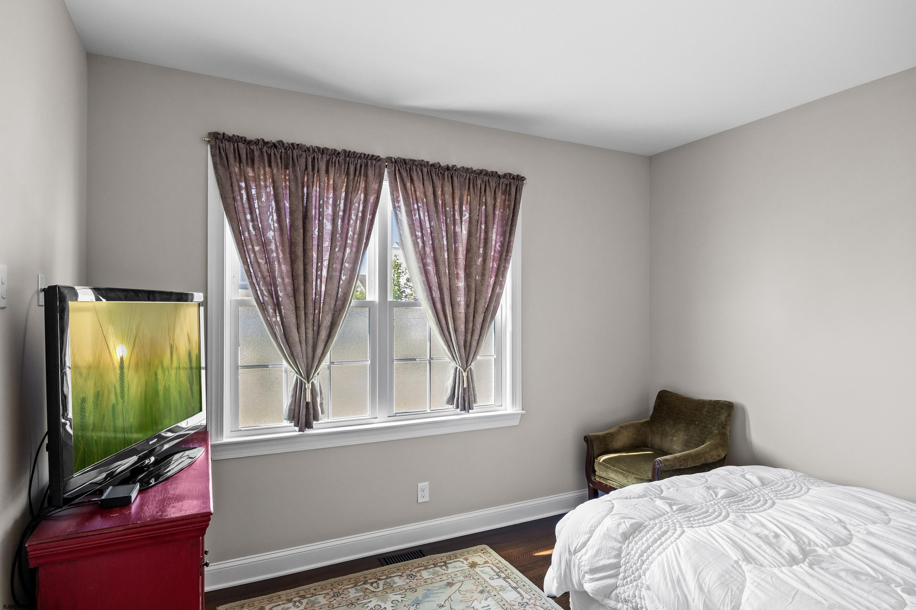 215 Surf Road Egg Harbor Township, NJ 08234 - Photo 19 of 31 a bedroom with a bed and a flat tv screen on dresser