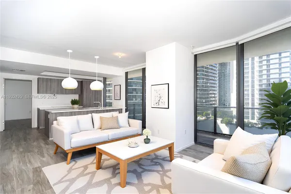 a living room with furniture and a potted plant