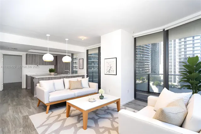 a living room with furniture and a potted plant