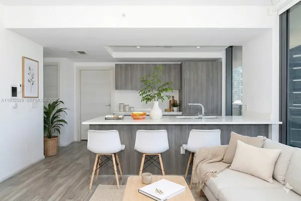 a living room with furniture and potted plant