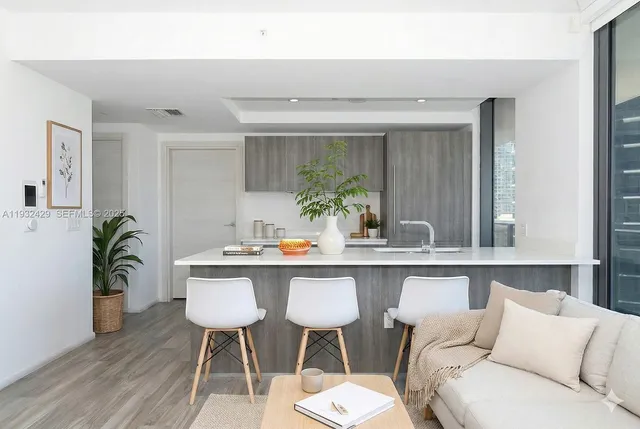 a living room with furniture and potted plant
