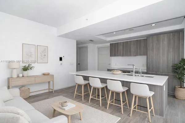 a kitchen with a dining table chairs and white cabinets